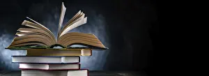 Educational Institution Stampe: A composition with an open book lying on a stack of other books