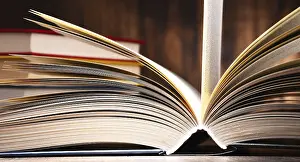 Literature And Wisdom Concept Stampe: Composition with open book on the table