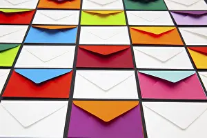Colourful Desk Supplies Stampe: Composition with white and colored envelopes on the table