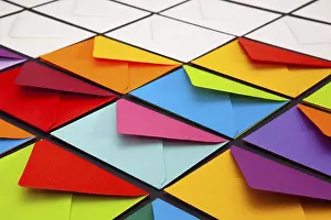 Multicolored Writing Utensils Stampe: Composition with white and colored envelopes on the table