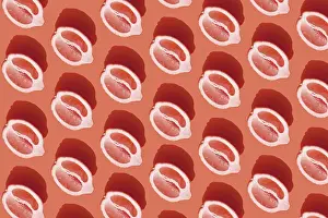 Red Background Design Stampe: Conceptual pattern with halves of lemon with shadow on red background