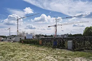 Urban Construction Site Stampe: Construction cranes in a new development area