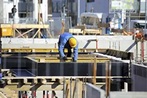 House Building Stampe: Construction work on the foundations of a large apartment building