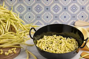 Scarlet Runner Bean Stampe: A cooking pot full of sliced beans on a kitchen worktop