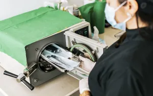 Healthcare Professional Work Stampe: A dentist sterilizing his tools