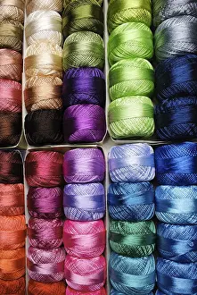 Embroidery Shop Stampe: Different color threads on rows in the store