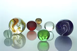 Empty Space For Text Copy Room Stampe: Several differently colored marbles on a mirror surface