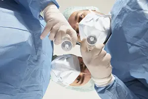 Healthcare Professionals Teamwork Stampe: Two doctors getting ready to administer an injection