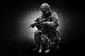 German Shepherd Breed Stampe: Dog handler posing in the studio with a trained shepherd