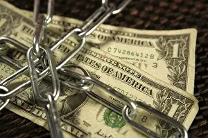 Brown Background Studio Shot Stampe: One Dollar notes in chains studio shot over brown background