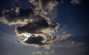 Cloudy Sky With Sun Stampe: Dramatic cloudy sky with sun behind it