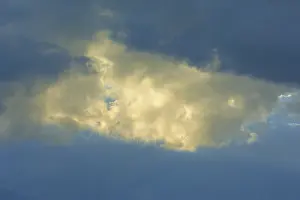 Dramatic Sky Stampe: Dramatic sky with bright clouds in the sunlight shining through a gap