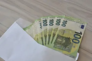 Corruption Symbol Stampe: Many one hundred euro notes in an envelope on a table
