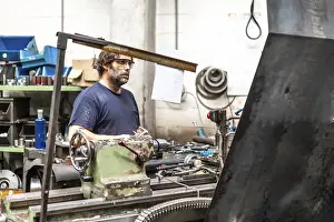 Factory Worker Stampe: Factory worker operator in the numerical control sector working on a machine