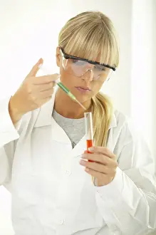 Laboratory Equipment Use Stampe: Female lab worker testing and experimenting