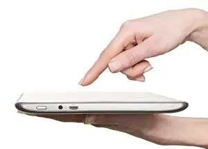 Woman Using Tablet Stampe: Finger pointing at a tablet computer screen