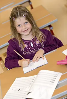 School Enrolment Process Stampe: Firstgrader during a lesson