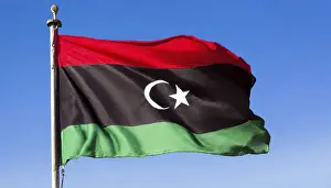Blue Sky With Flag Fluttering Stampe: The flag of Libya, fluttering in the wind