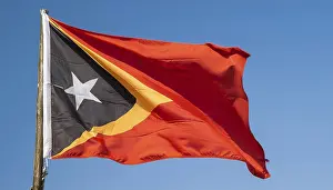 Blue Skies With Flags Stampe: The flag of Timor, fluttering in the wind