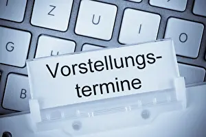 Mortgage Savings Plan Stampe: The folder of a hanging file in front of a computer keyboard on the subject of presentation dates