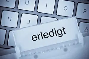 Mortgage Savings Plan Stampe: The folder of a hanging file in front of a computer keyboard on the topic done