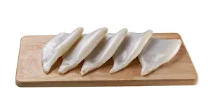 Cuttlefish On Cutting Board Stampe: Fresh Raw Squid or Cuttlefish Fillet on Cutting Board Isolated on a White Background