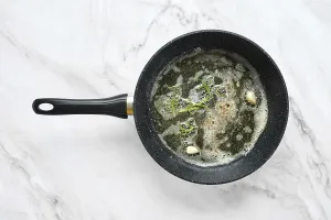 Savory Meal Preparation Stampe: A frying pan is on a marble surface