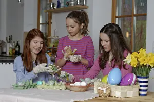 Colourful Easter Eggs Germany Stampe: Girls colouring Easter eggs for Easter