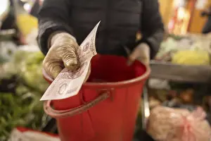 Colorful Street Scene Stampe: A gloved hand exchanges a banknote over a red container
