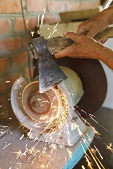 Handicraft Tools Stampe: Grinding table ax with a grinding machine at close range