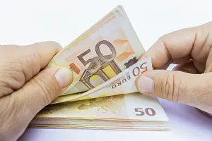 Euro Banknote Stampe: Two hands counting stack of 50 euro notes