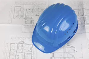 Deserted Construction Site Europe Stampe: Hard hat lying on a construction plan