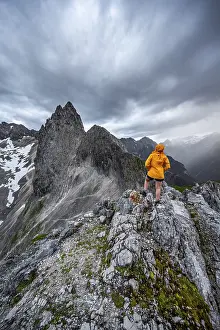 Wetterstein Mountains Scenery Stampe: Hiker looking at mountains under dramatic clouds