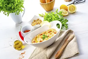 Healthy Snack Ideas Stampe: Hummus paste with lemon and chilli on a white background