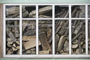 Piled Up Firewood Stampe: Indoor environment featuring a window