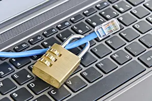 Secure Internet Connection Stampe: Internet cable and padlock on computer keyboard symbolizing data security
