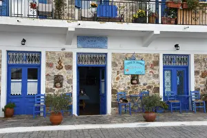 Peloponnese Travel Photography Stampe: Inviting cafe with blue elements and stone wall