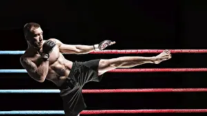 Mixed Martial Arts Concept Stampe: Kickboxer posing in the ring. Middle Kick