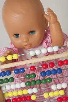 Educational Institution Image Stampe: Learning arithmetics, doll using an abacus