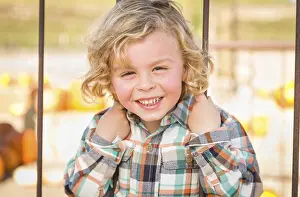 Rustic Ranch Setting Stampe: Little boy having fun in a rustic ranch setting at the pumpkin patch