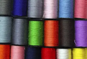 Deserted Background Stampe: Lot of colored thread spools, background