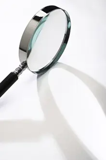Close Up Concept Image Stampe: Magnifying glass casting a shadow