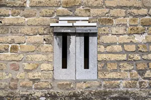 Deserted Postal Service Stampe: Mailboxes integrated into a brick wall