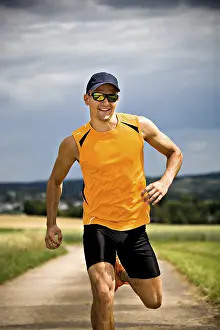 Athletic Man Stampe: Man jogging through the fields