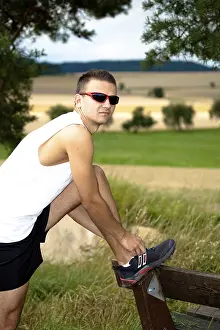 Outdoor Recreational Activity Stampe: Man jogging through the fields