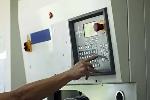 Passenger Traffic Control Stampe: Man presses button on electronic control panel