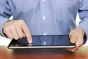 Tablet Pc Usage Stampe: Man using a tablet computer