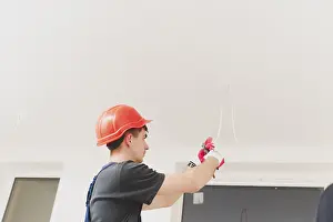 Manual Labor Work Stampe: Man working with cables ceiling