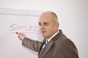 Studio Shot Of A Manager Stampe: Manager standing in front of a flip chart