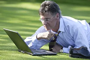 Caucasian Male Professional Stampe: Manager working on notebook in parc